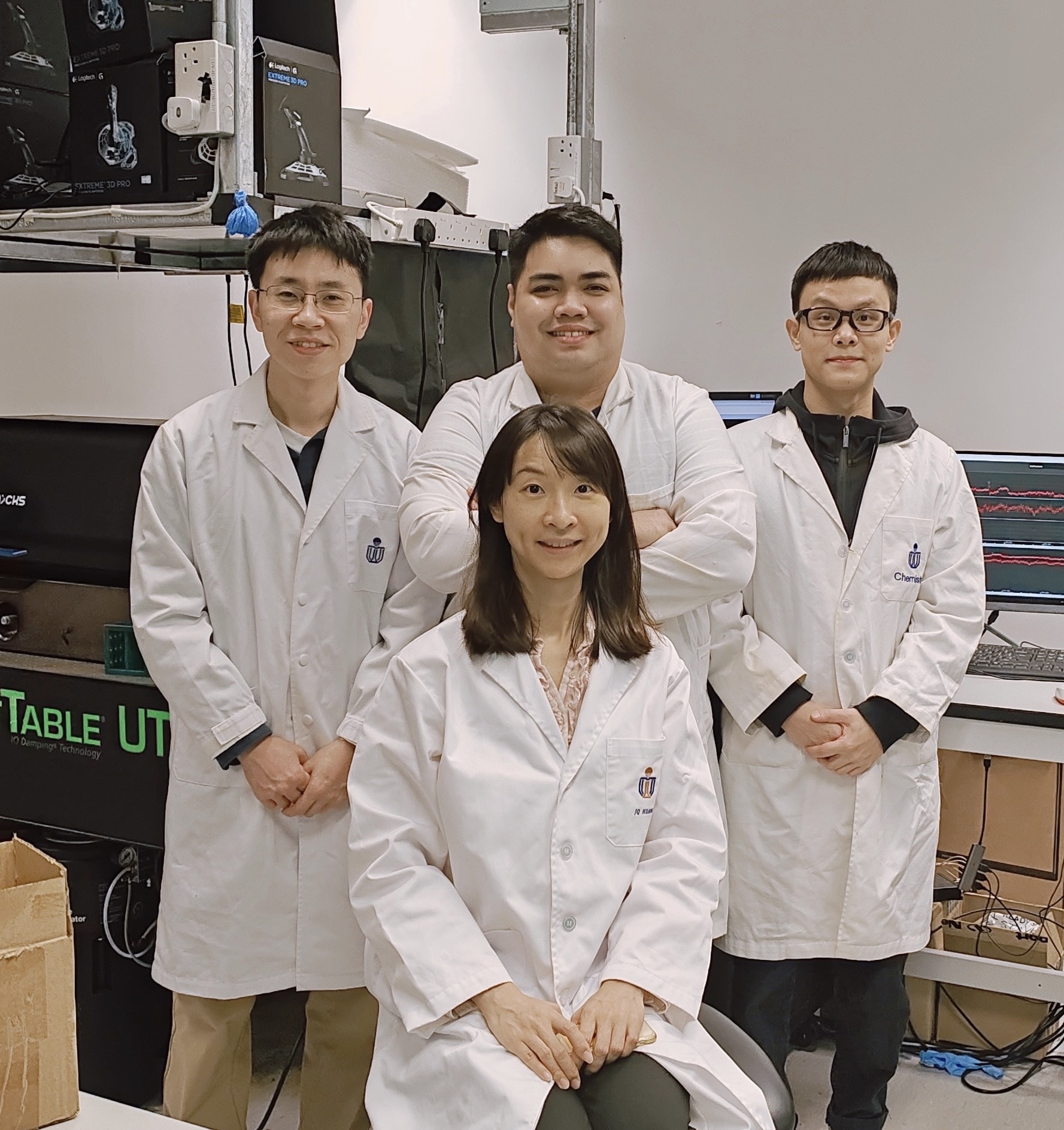 A group photo of Prof. HUANG Jinqing (front row), and members on her research team, including then Postdoctoral Research Fellow Dr. DAI Xin (left, second row), PhD students MESIAS St. Dollente Vince (middle, second row), and FU Wenhao (right, second row) at the Department of Chemistry at HKUST